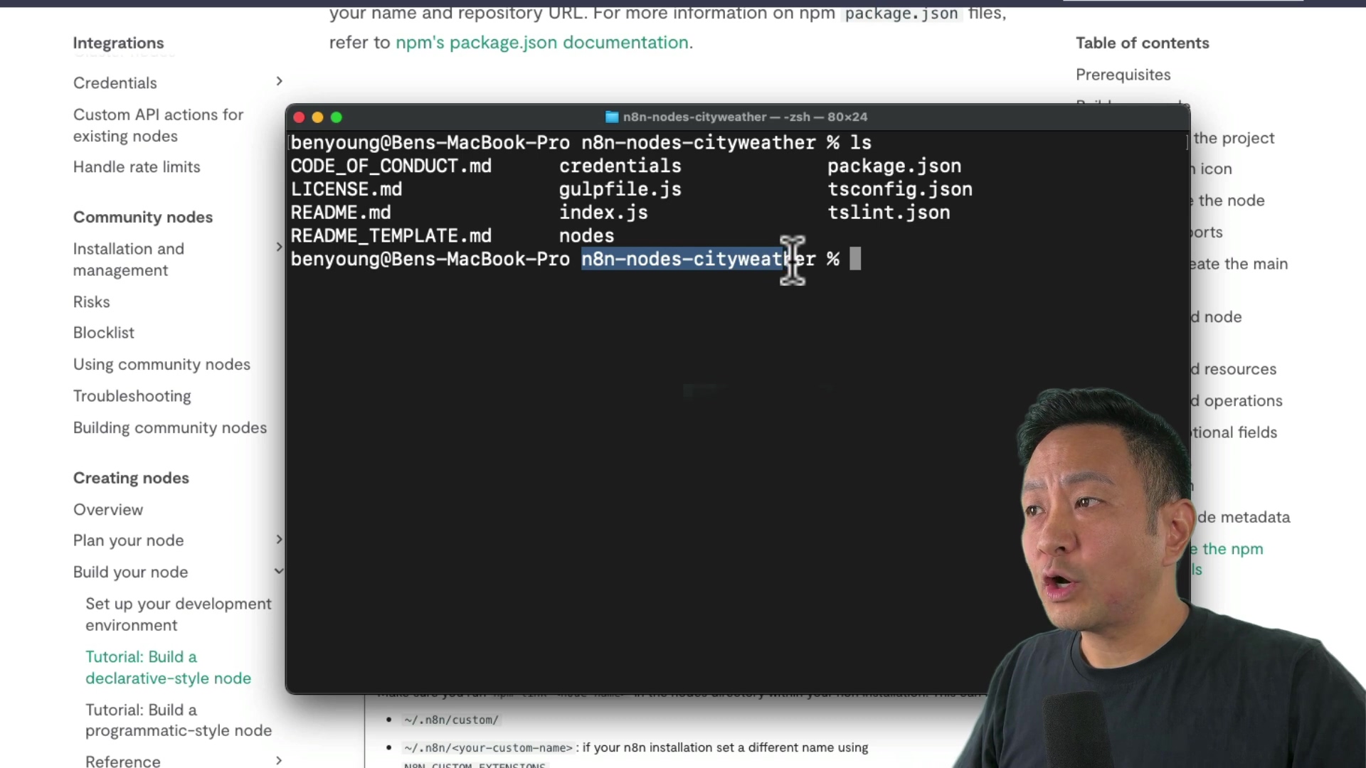 The image shows a terminal window on what appears to be a macOS system, displaying the contents of the 'n8n-nodes-cityweather' directory. The files listed include 'CODE_OF_CONDUCT.md', 'credentials', 'LICENSE.md', 'README.md', 'README_TEMPLATE.md', 'nodes', 'package.json', 'gulpfile.js', 'tsconfig.json', and 'tslint.json'. The current directory in the terminal is 'benyoung@Bens-MacBook-Pro n8n-nodes-cityweather'. To the left is a portion of a documentation page with sections like 'Integrations', 'Credentials', 'Community nodes', and 'Creating nodes'. A person is partially visible on the right.