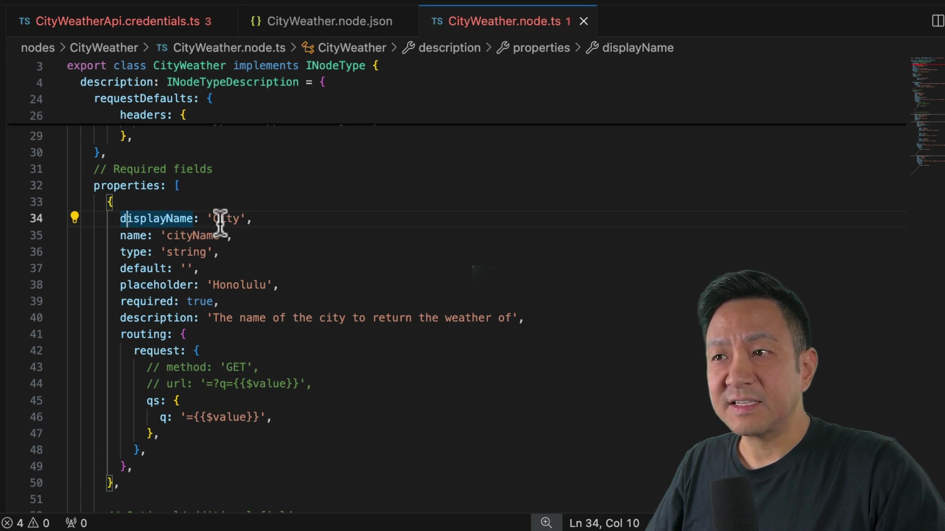The image shows a screen recording of code being edited in what appears to be Visual Studio Code. The code relates to a 'CityWeather' node, with the file name 'CityWeather.node.ts' visible in the tab. The code includes properties such as 'displayName', 'name', 'type', 'default', 'placeholder', 'required', and 'description'. A man is visible in the lower right corner, seemingly explaining the code.