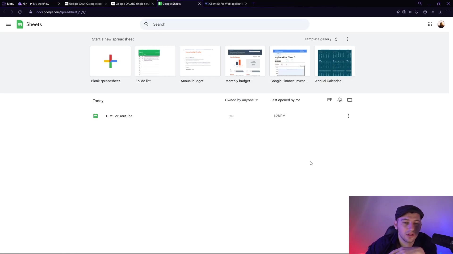 The image displays the Google Sheets interface, showing a list of spreadsheets. The top section features options to 'Start a new spreadsheet' with a large plus icon for 'Blank spreadsheet' and various templates like 'To-do list', 'Annual budget', 'Monthly budget', 'Google Finance Invest...', and 'Annual Calendar'. Below this, a section titled 'Today' shows a single spreadsheet named 'TEST For Youtube', indicating it was 'Owned by anyone', 'Last opened by me', and opened at '1:28 PM'. The interface includes a search bar, a menu icon, and user profile icons at the top. A person's head and shoulders are visible in the bottom right corner.