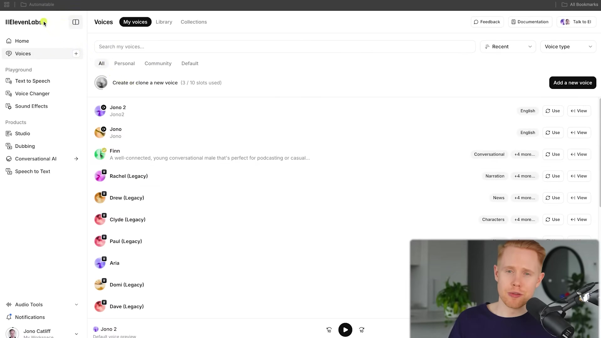 The image displays the ElevenLabs voice cloning interface. The left sidebar shows navigation options like 'Home', 'Text to Speech', 'Voice Changer', 'Sound Effects', 'Studio', 'Dubbing', 'Conversational AI', and 'Speech to Text'. The main section is titled 'My voices' and lists several cloned voices, including 'Jono 2', 'Jono', 'Finn', 'Rachel (Legacy)', 'Drew', 'Clyde', 'Paul', 'Aria', 'Domi', and 'Dave (Legacy)'. Each voice entry includes options for 'English', 'Use', and 'View'. A button to 'Add a new voice' is prominent. The interface indicates '3 / 10 slots used' for creating or cloning a new voice. A red-haired man is visible in the bottom right corner, looking at the screen and talking.