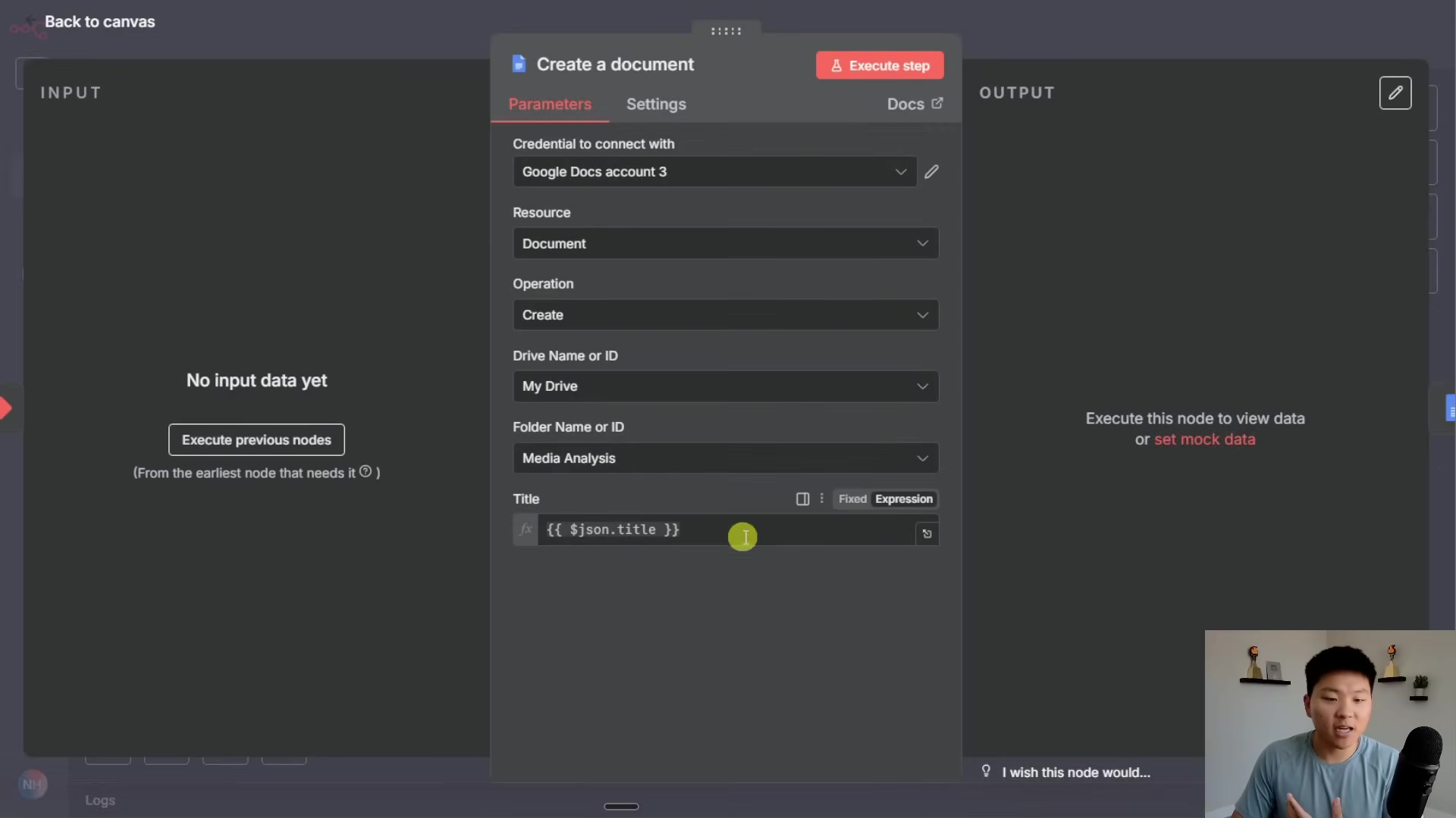 The image shows a dark-themed n8n interface with a modal window titled 'Create a document'. This modal is focused on configuring a Google Docs integration. It has tabs for 'Parameters', 'Settings', and 'Output'. Under 'Parameters', fields include 'Credential to connect with' (showing 'Google Docs account 3'), 'Resource' (set to 'Document'), 'Operation' (set to 'Create'), 'Drive Name or ID' (showing 'My Drive'), 'Folder Name or ID' (showing 'Media Analysis'), and 'Title' with an input field containing '{{ $json.title }}'. On the left, a panel says 'No input data yet' with a button 'Execute previous nodes'. On the right, 'Execute this node to view data' or 'set mock data' is displayed. A person is visible in the bottom right corner, looking at the screen and speaking.