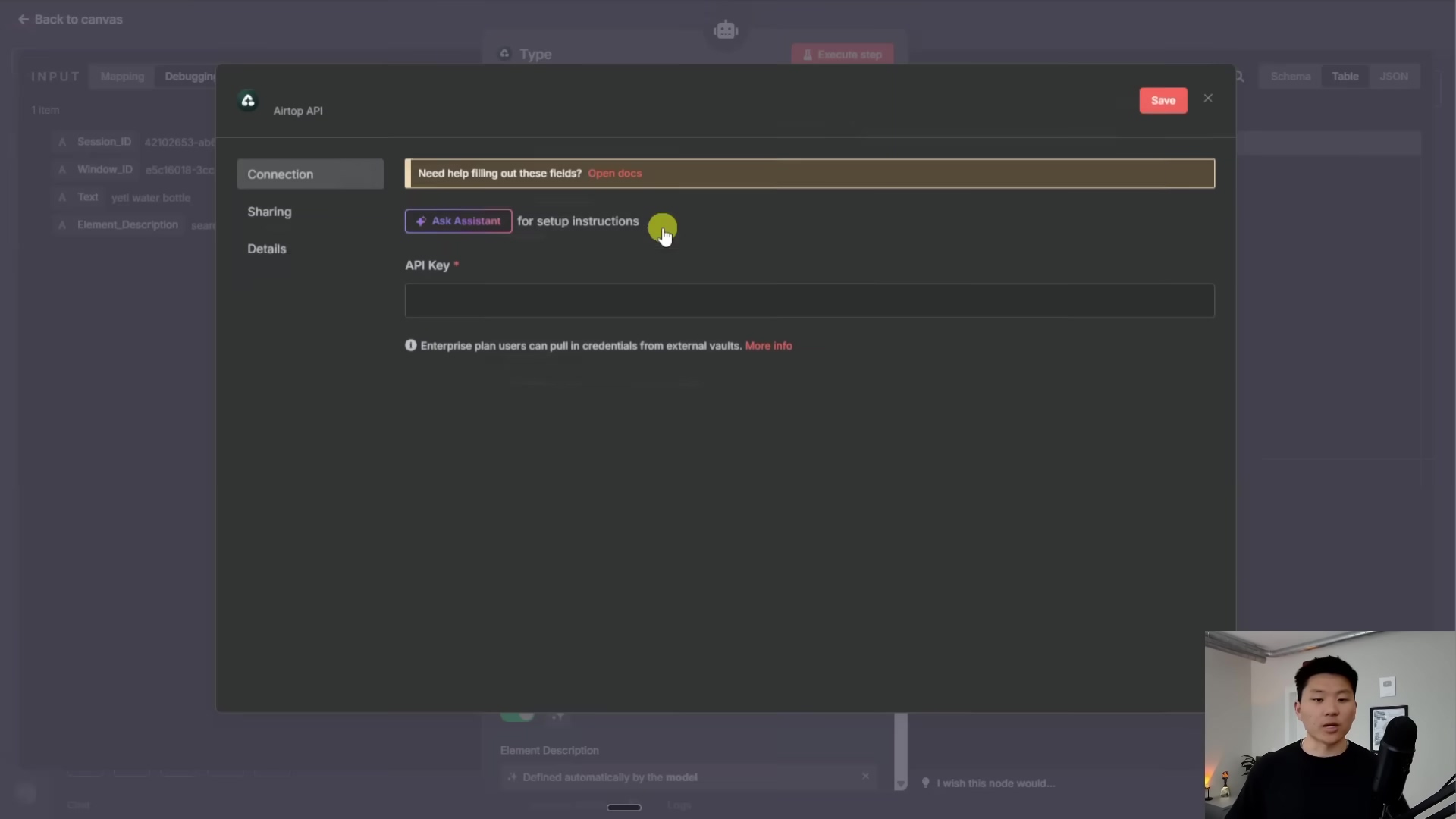 The image displays a dark-themed software interface, likely a pop-up window or modal, for configuring an 'Airtop API' connection. The window has a title bar with 'Airtop API' and a 'Save' button in the top right. Below the title, there's a section for 'Connection' with a prompt 'Need help filling out these fields? Open docs'. A 'Sharing' section contains a button labeled 'Ask Assistant for setup instructions'. The main input area is for 'Details', specifically an 'API Key' field marked with an asterisk, indicating it's required. Below this, there's a small informational text: 'Enterprise plan users can pull in credentials from external vaults. More info'. The background shows a blurred n8n canvas with nodes and connections.