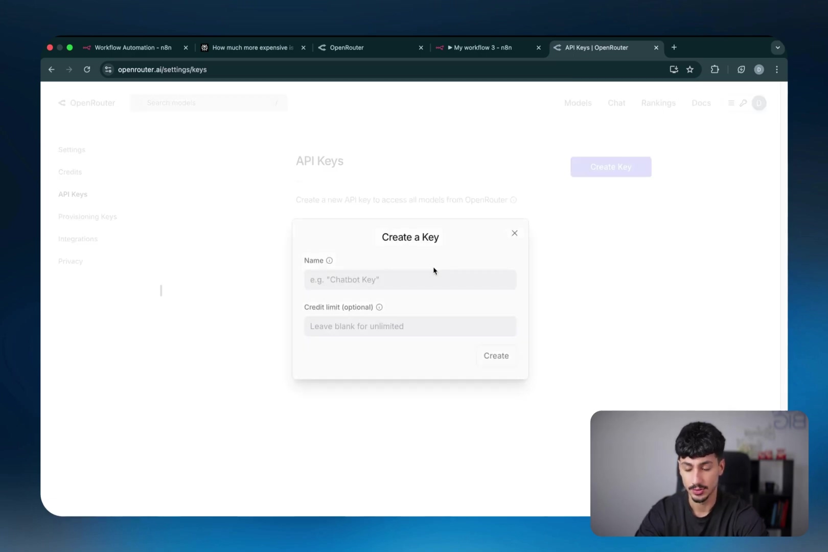 The image displays the OpenRouter web interface, specifically the 'API Keys' section. A modal window titled 'Create a Key' is open in the center, prompting the user to enter a 'Name' for the key (e.g., "Chatbot Key") and an optional 'Credit limit'. On the left sidebar, navigation options like 'Settings', 'Credits', 'API Keys', 'Provisioning Keys', 'Integrations', and 'Privacy' are visible. The main content area behind the modal shows 'API Keys' as a heading and a 'Create Key' button. A small video overlay of a man speaking is visible in the bottom right corner.