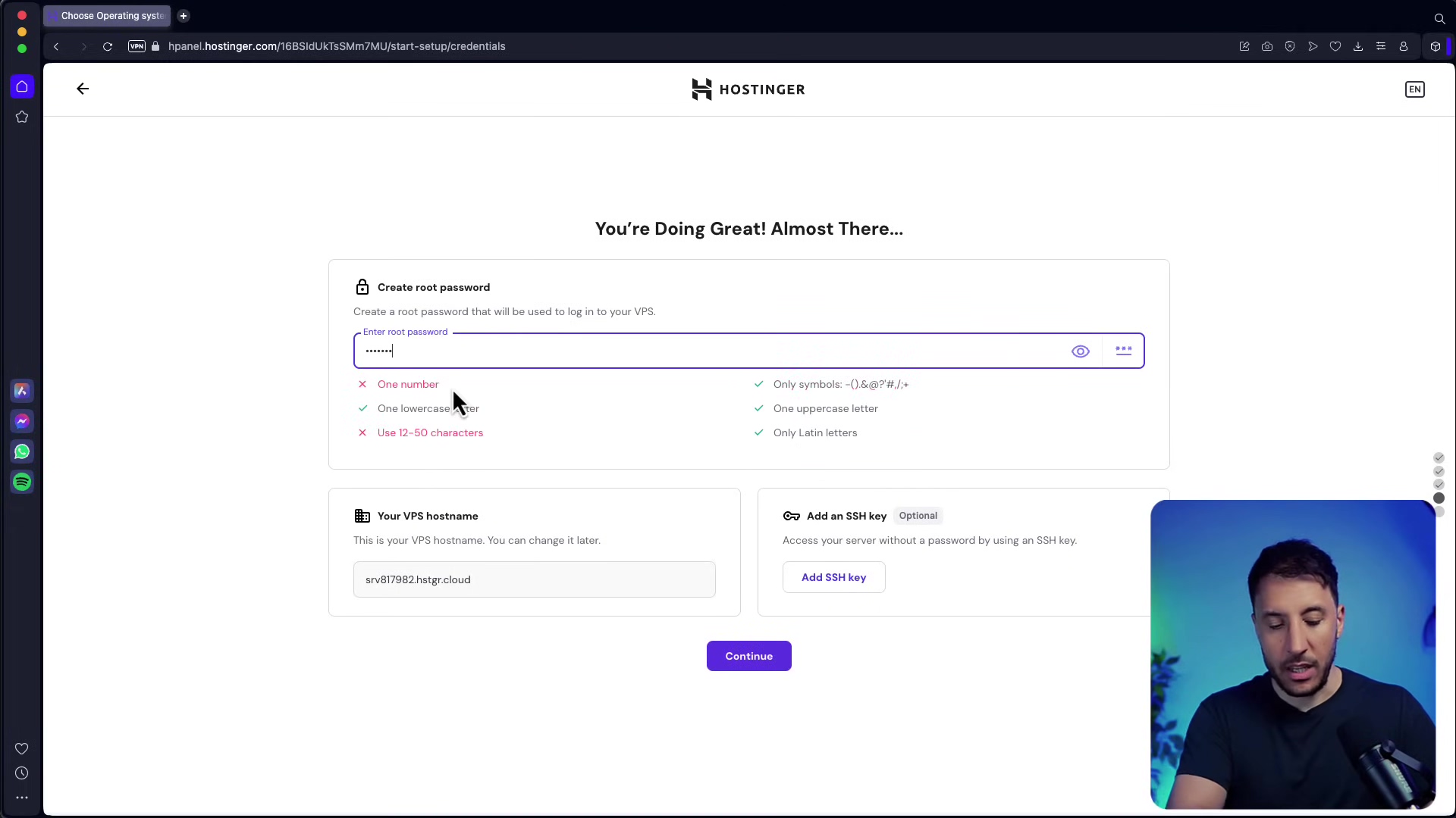 The image shows a Hostinger control panel interface with a section for setting up login credentials. The main heading reads "You're Doing Great! Almost There...". Below this, there's a section to "Create root password" for logging into the VPS. An input field for "Enter root password" is visible with a masked password. Password requirements are listed with checkmarks: "One number," "One lowercase letter," "One uppercase letter," "Only symbols - !@#$%^&*()_+", "Use 12-50 characters," and "Use Latin letters." All requirements are checked except for "One number" and "One lowercase letter," which have red 'x' marks. Further down, there's a section for "Your VPS hostname" with an input field showing "srv877982.hostngr.cloud" and an option to "Add an SSH key." A purple "Continue" button is at the bottom. A man is visible in the bottom right corner of the screen, looking towards the interface.
