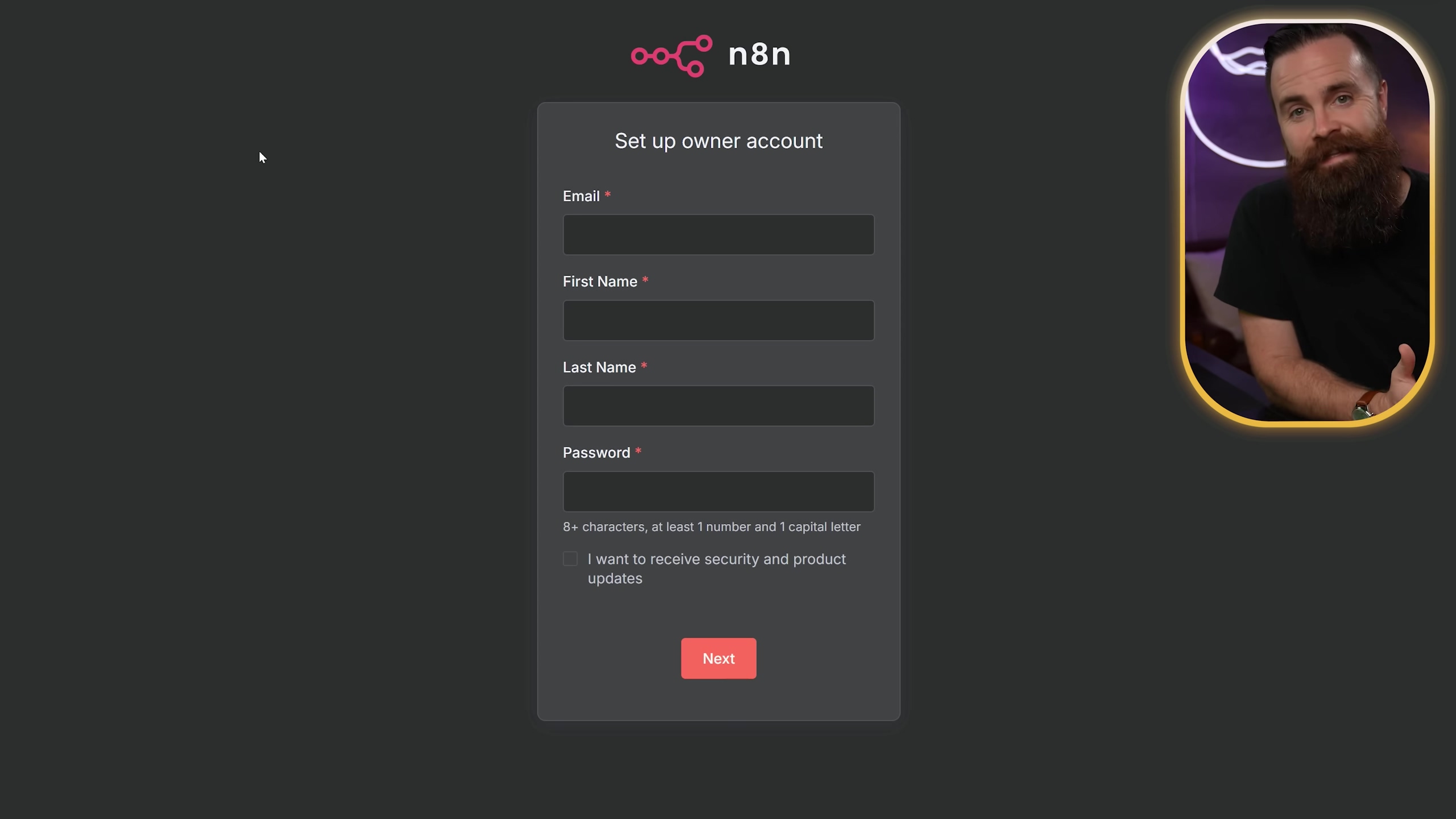 The image displays a dark grey interface for setting up an n8n owner account. At the top, the n8n logo, which consists of interconnected nodes, is visible next to the text 'n8n'. Below this, a form with the title 'Set up owner account' is presented. The form fields include 'Email *', 'First Name *', 'Last Name *', and 'Password *', each with an input box below it. Under the password field, there's a note '8+ characters, at least 1 number and 1 capital letter'. A checkbox labeled 'I want to receive security and product updates' is also present. At the bottom of the form, there's a red 'Next' button. In the upper right corner, a small, circular inset shows the presenter, NetworkChuck, smiling and looking towards the form, with a purple background.