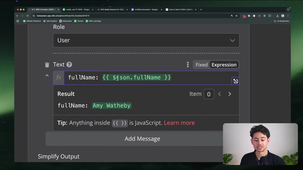 The image shows a section of the n8n interface focusing on a 'Text' input field. Below the 'Role' dropdown, which is set to 'User', there's a field labeled 'Text' with a small 'fx' icon indicating it's an expression field. The field contains the expression {{ $json.fullName }}. Below this, a 'Result' section displays 'fullName: Amy Watheby', indicating the output of the expression. A 'Tip' box at the bottom explains that anything inside {{ }} is JavaScript. The speaker is visible in the bottom right corner, looking at the screen.