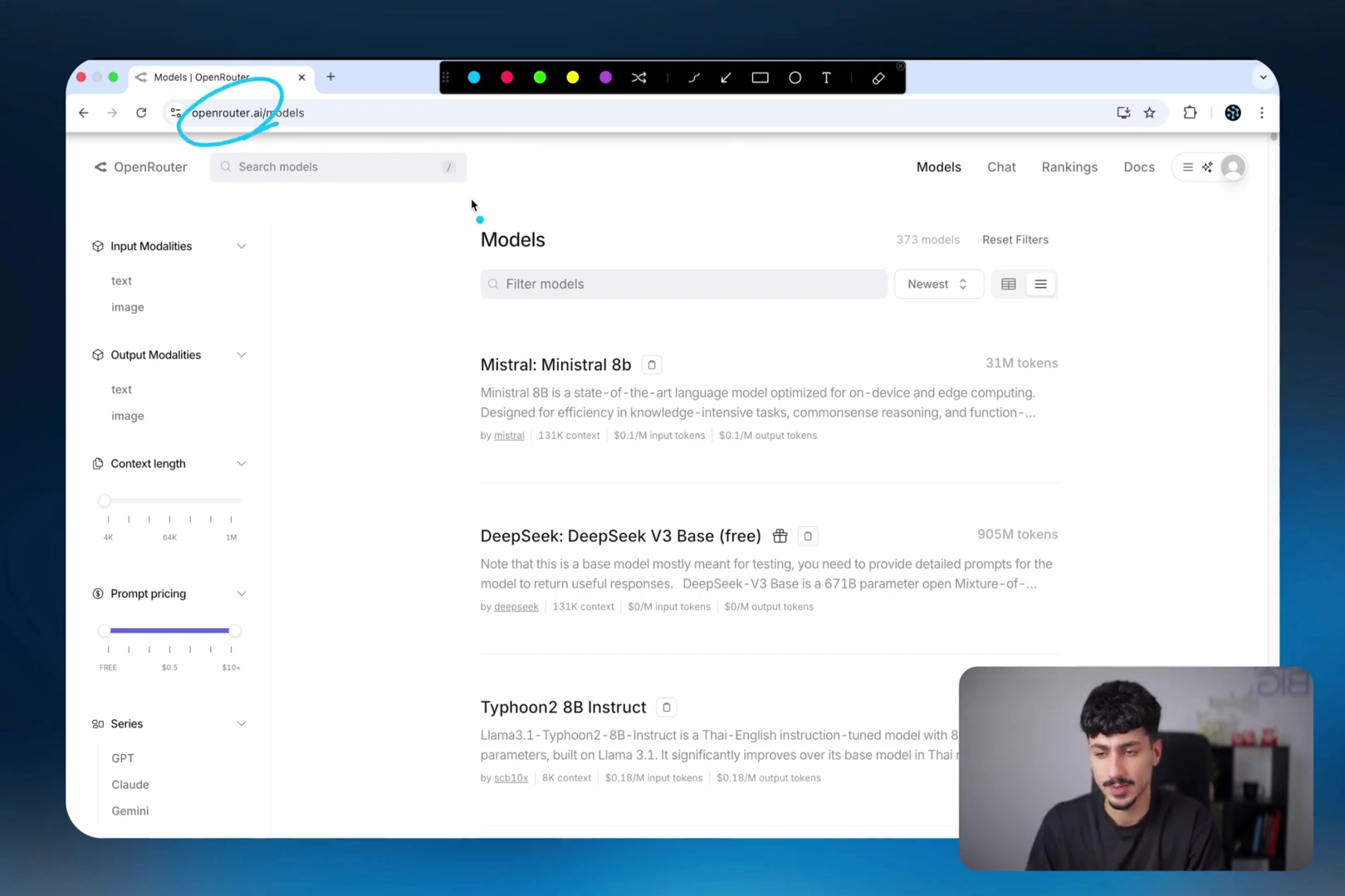 The image shows a web browser displaying the OpenRouter.ai models page. The URL bar shows 'openrouter.ai/models'. The page features a search bar labeled 'Search models' and a 'Filter models' input field. On the left sidebar, there are sections for 'Input Modalities' (text, image) and 'Output Modalities' (text, image), and 'Prompt pricing' with a slider. The main content area lists various AI models with their token counts and pricing information, such as 'Mistral: Mistral 8b', 'DeepSeek: DeepSeek V3 Base (free)', and 'Typhoon 2B Instruct'. Each model entry includes details like 'input tokens' and 'output tokens' pricing. A man is visible in the bottom right corner, looking at the screen.