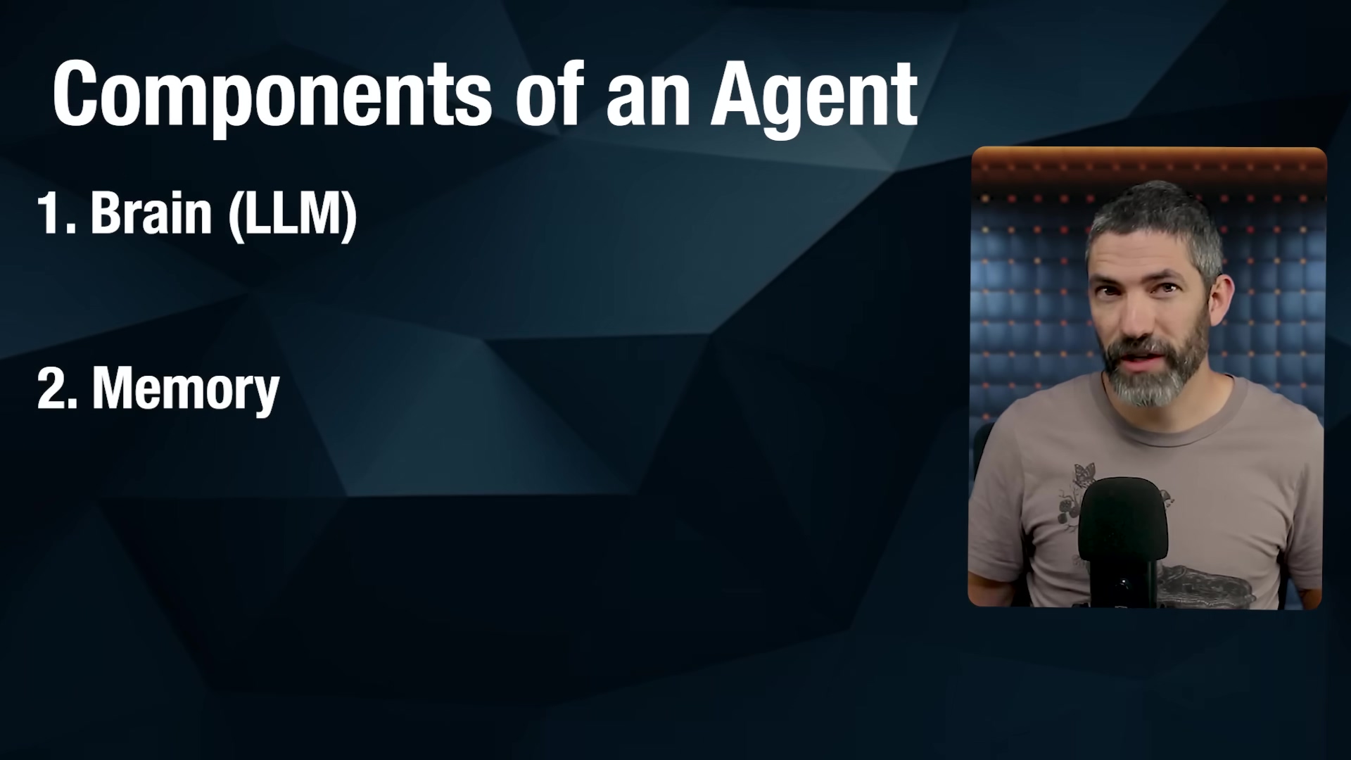 The image displays a list of 'Components of an Agent' on a dark blue background with geometric patterns. The main heading 'Components of an Agent' is in large white font at the top left. Below it, a numbered list begins with '1. Brain (LLM)' and '2. Memory', both in white font. In the upper right corner, a speaker with a beard and short hair is visible, looking directly at the camera. He is wearing a light brown t-shirt and is positioned in front of a dark blue padded wall.