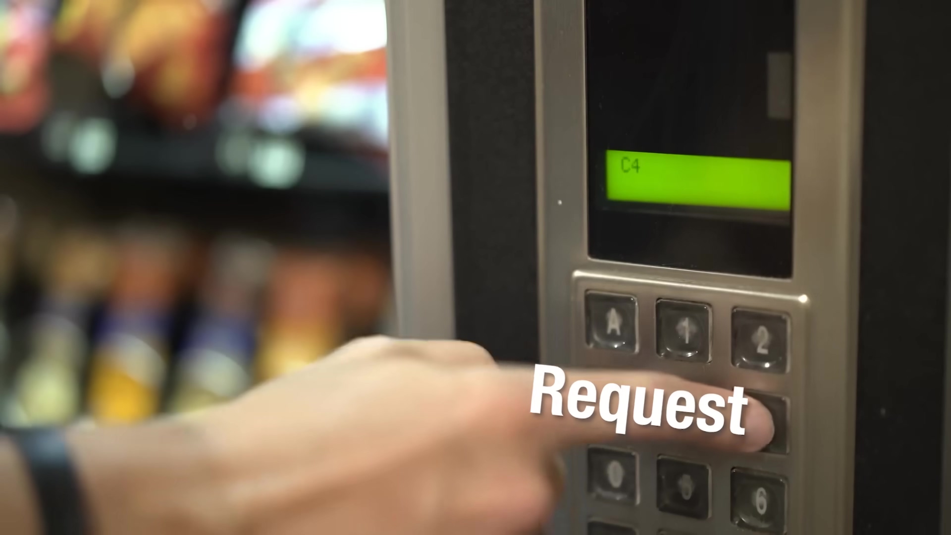 The image shows a close-up of a person's hand pressing a button on a vending machine-like interface. The interface has a numeric keypad with buttons labeled 1 through 9, A, B, C, D, and an asterisk and pound sign. Above the keypad, there's a small digital display showing 'C4' in green text on a black background. The person's finger is pressing the '5' button. The word 'Request' is overlaid in large white text with a slight shadow, positioned over the keypad. The background is blurred, showing what appears to be shelves with products, typical of a vending machine environment.