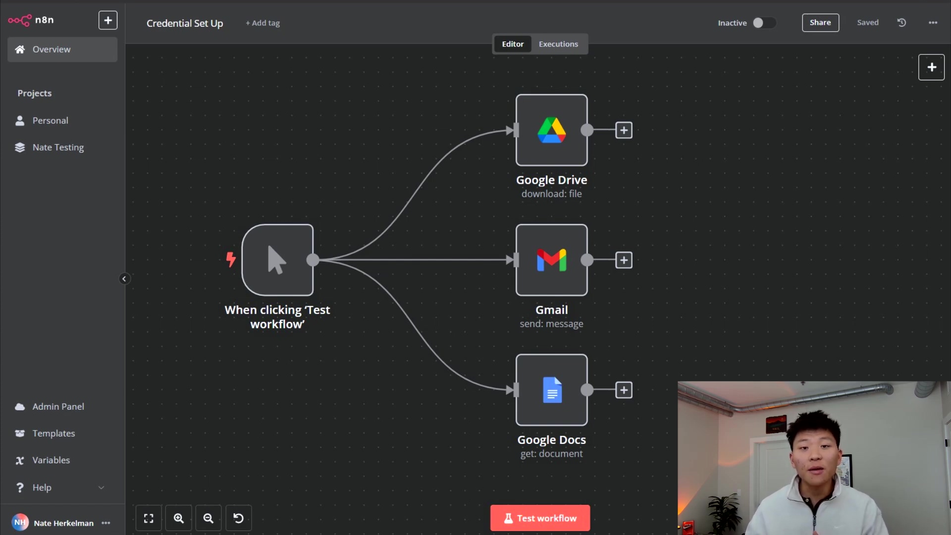 The image displays a dark-themed n8n workflow interface. On the left, a vertical navigation bar shows 'Overview', 'Projects' with 'Personal' and 'Nate Testing' sub-items, 'Admin Panel', 'Templates', 'Variables', and 'Help'. The main canvas features a workflow starting with a 'When clicking 'Test workflow'' trigger, branching out to three Google service nodes: 'Google Drive' (download: file), 'Gmail' (send: message), and 'Google Docs' (get: document). Each node has a plus icon next to it, indicating the ability to add more steps. At the top, there are options for 'Credential Set Up', 'Add tag', 'Editor', 'Executions', 'Inactive', 'Share', 'Saved', and a refresh icon. A person is visible in the bottom right corner, looking at the screen and speaking. The bottom bar includes various icons for zoom, search, and a 'Test workflow' button.