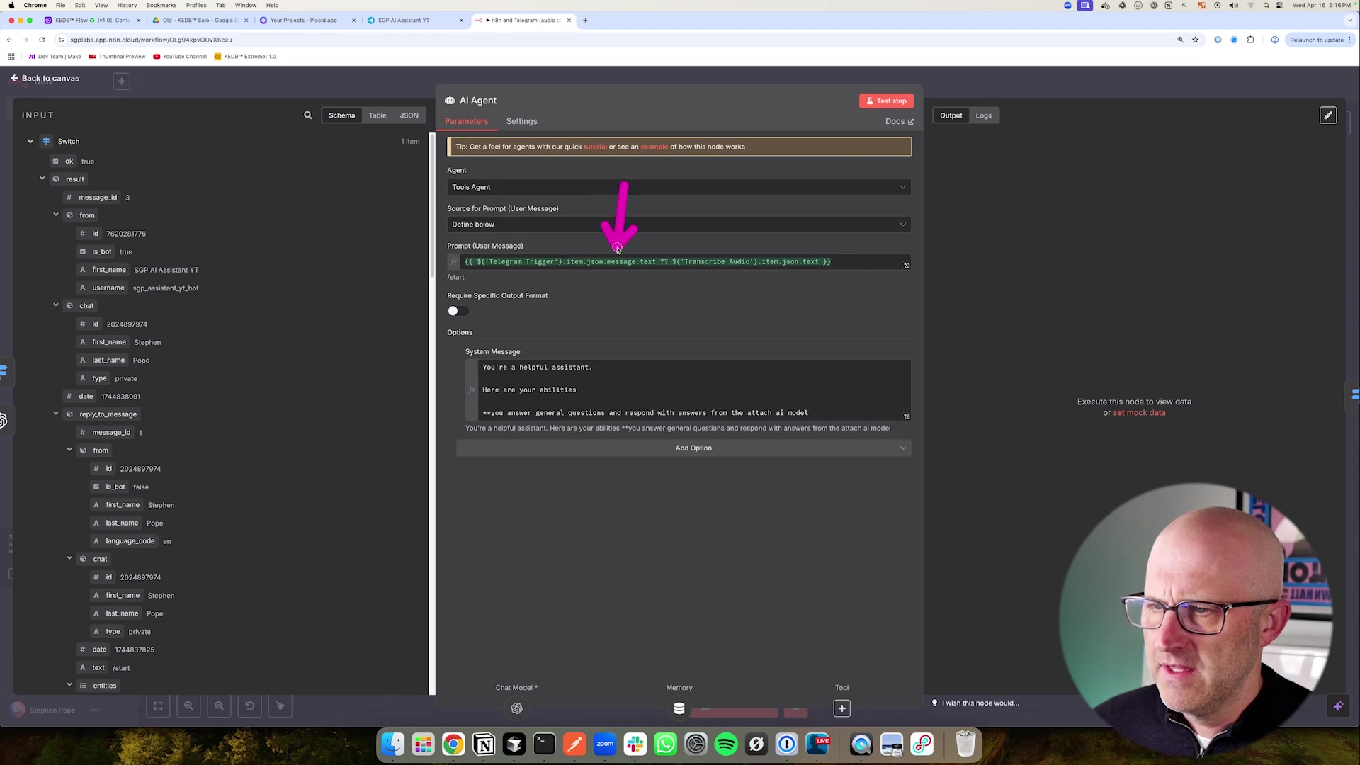 The image shows a software interface, specifically the configuration panel for an 'AI Agent' node within a workflow editor. The panel has 'Schema', 'JSON', 'Table', 'Parameters', and 'Settings' tabs, with 'Parameters' selected. Key sections include 'Agent' (set to 'Tool Agent'), 'Source for Prompt User Message', and 'Prompt User Message' which contains a conditional expression involving 'Telegram Trigger' and 'Transcribe Audio' nodes. A purple arrow cursor points to the 'Prompt User Message' field. Below this, there are 'Require Specific Output Format' and 'Options' sections. The 'System Message' field contains instructions for the AI assistant. A male presenter is visible in the bottom right, looking towards the screen. Browser tabs and system information are at the top.