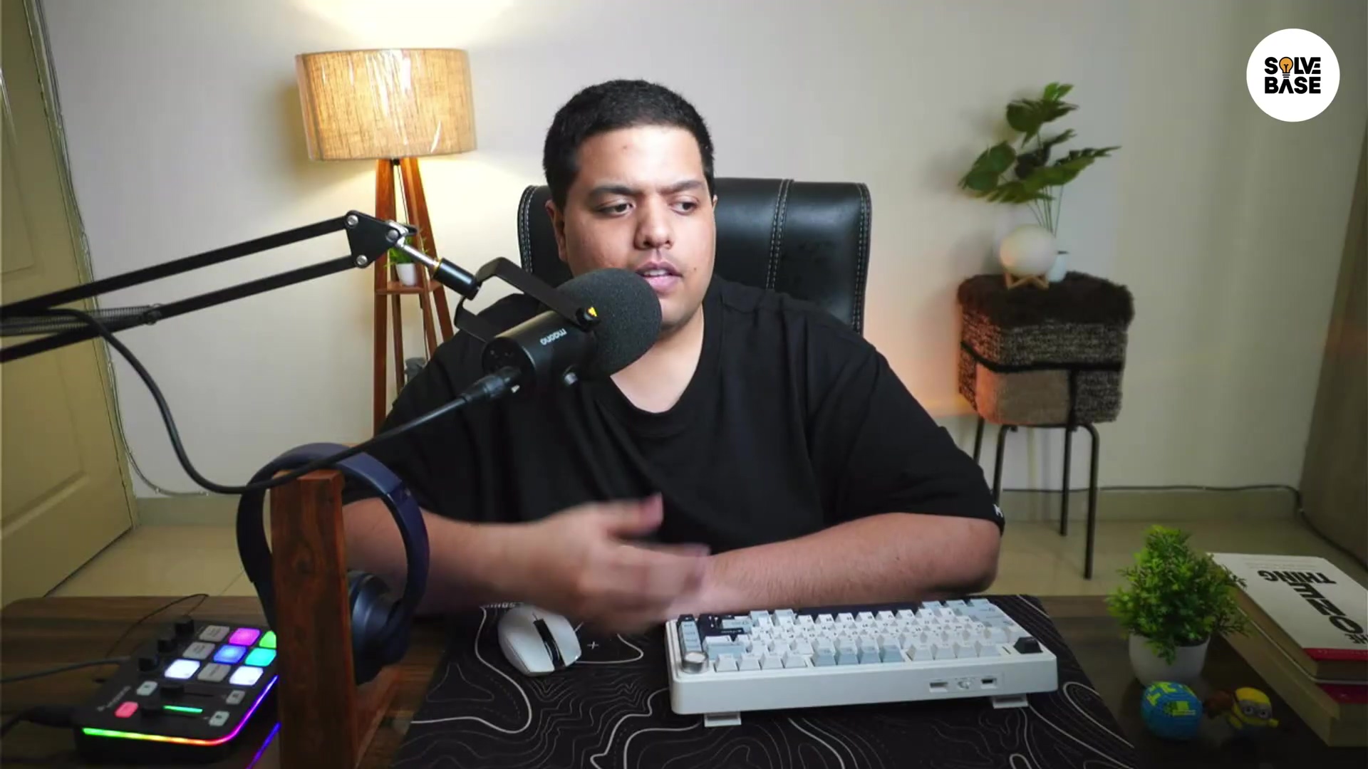 Person focused on desk setup with keyboard and microphone